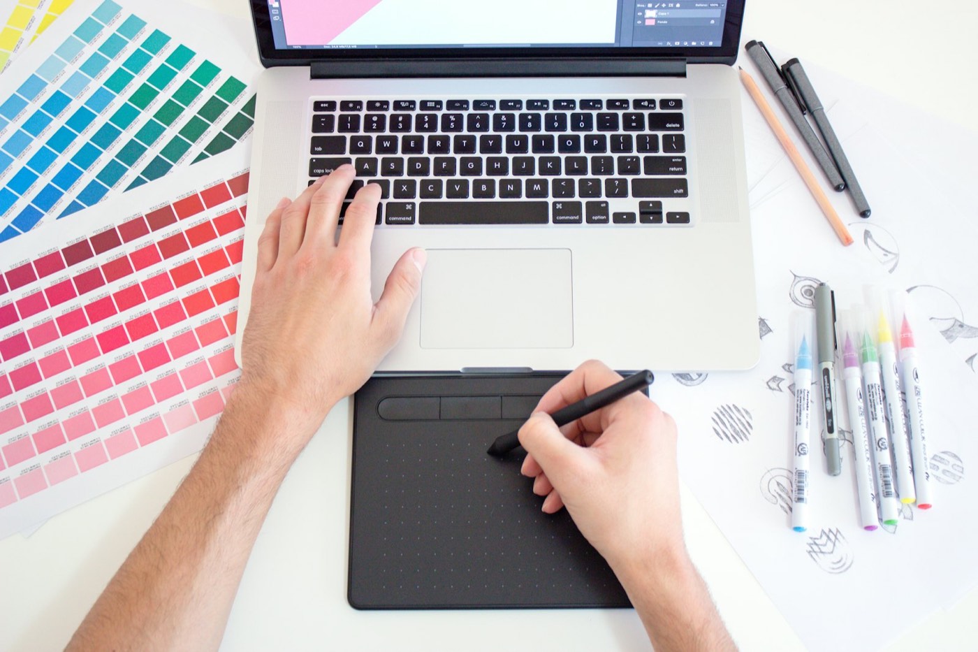 Designer working with colour swatches and a pen tablet