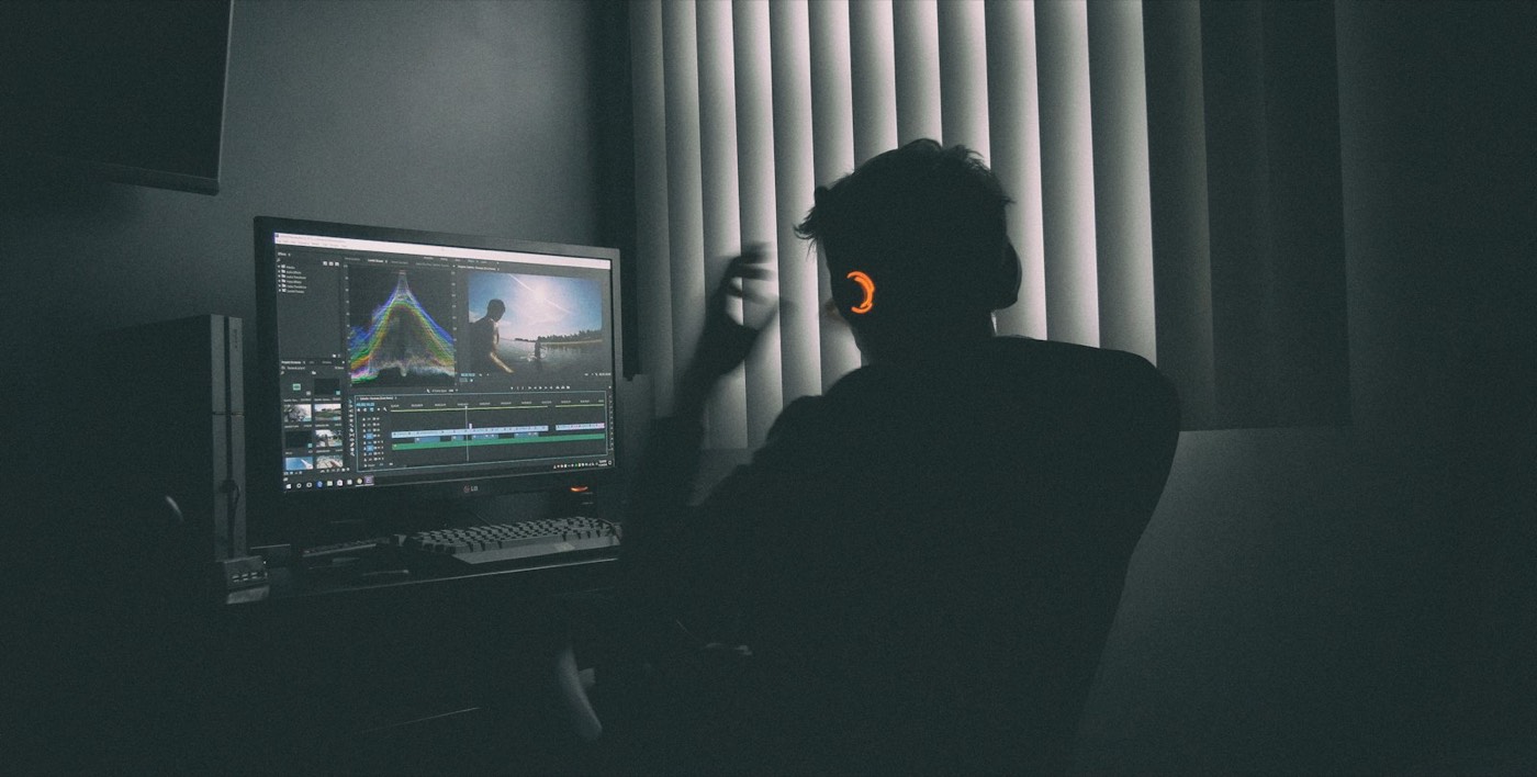 Editor at work in a dark edit suite